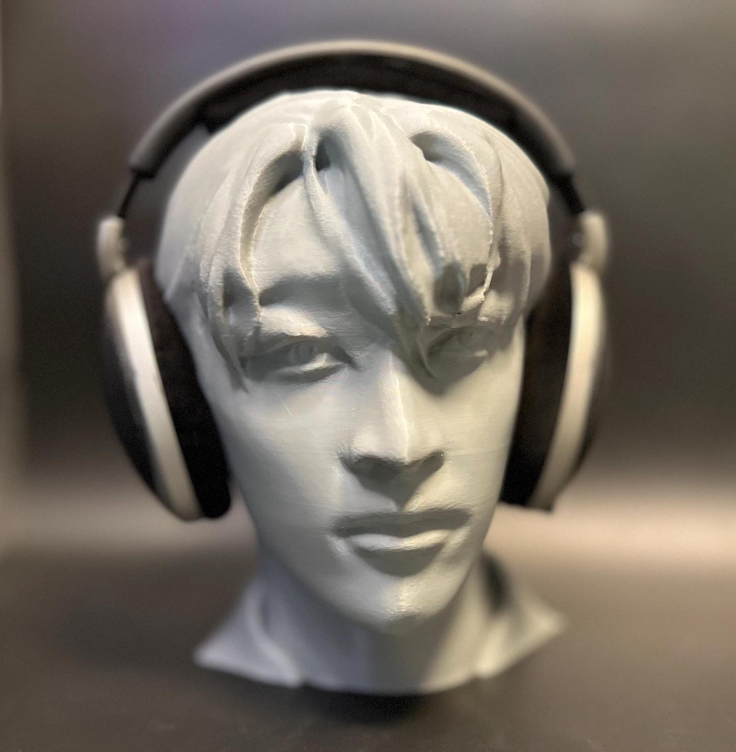 A meticulously crafted headphone stand inspired by Bang Chan. Available in various colors, including metallic finishes, showcasing sleek details and a premium design for Stray Kids fans and audiophiles alike.