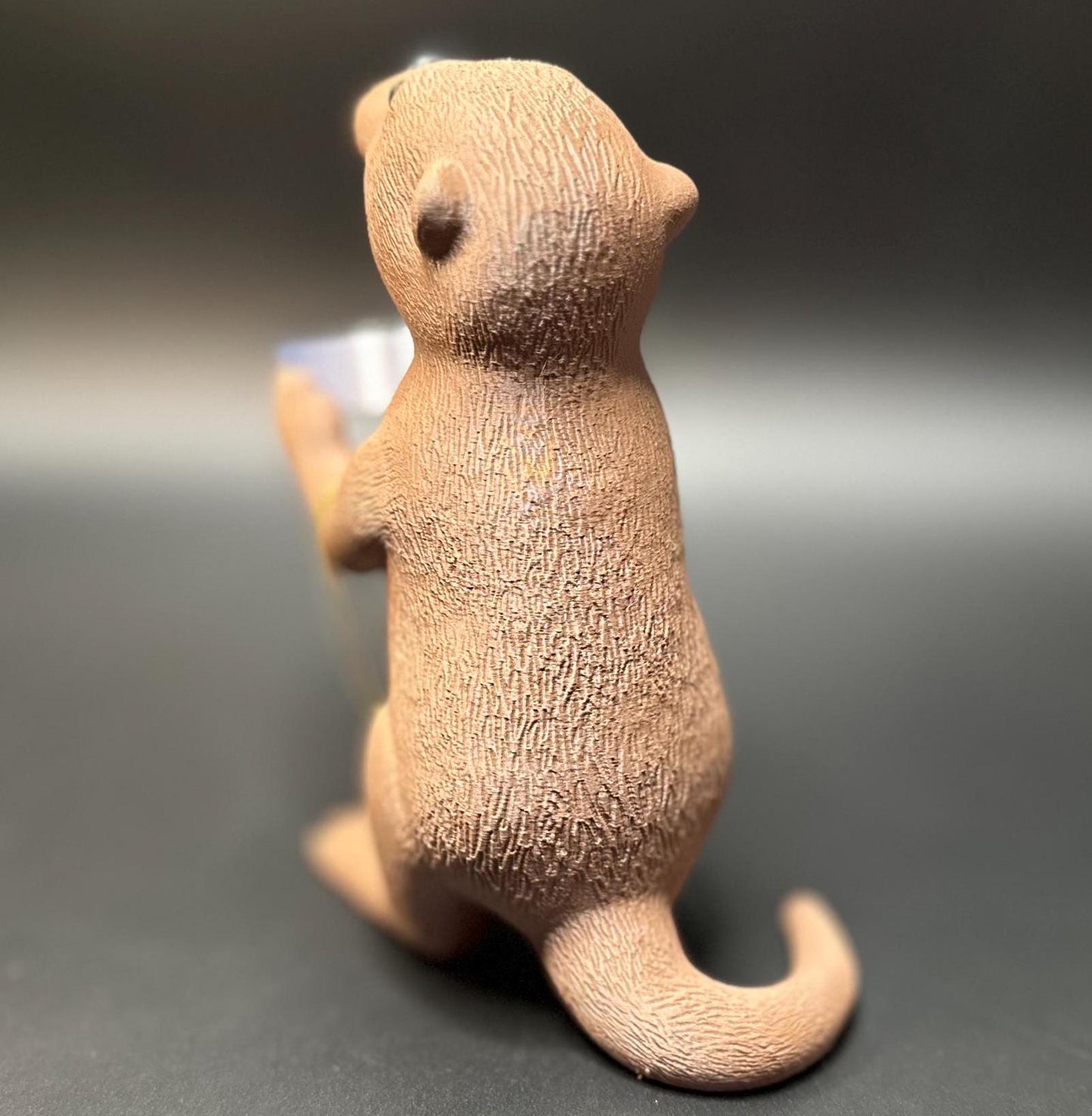 A cute otter-shaped jewelry holder with a trinket dish, available in multiple colors for added charm.