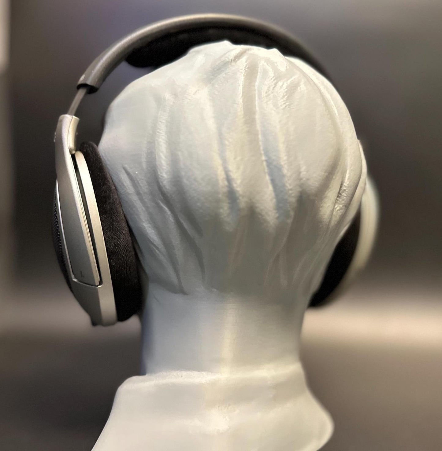 A meticulously crafted headphone stand inspired by Bang Chan. Available in various colors, including metallic finishes, showcasing sleek details and a premium design for Stray Kids fans and audiophiles alike.