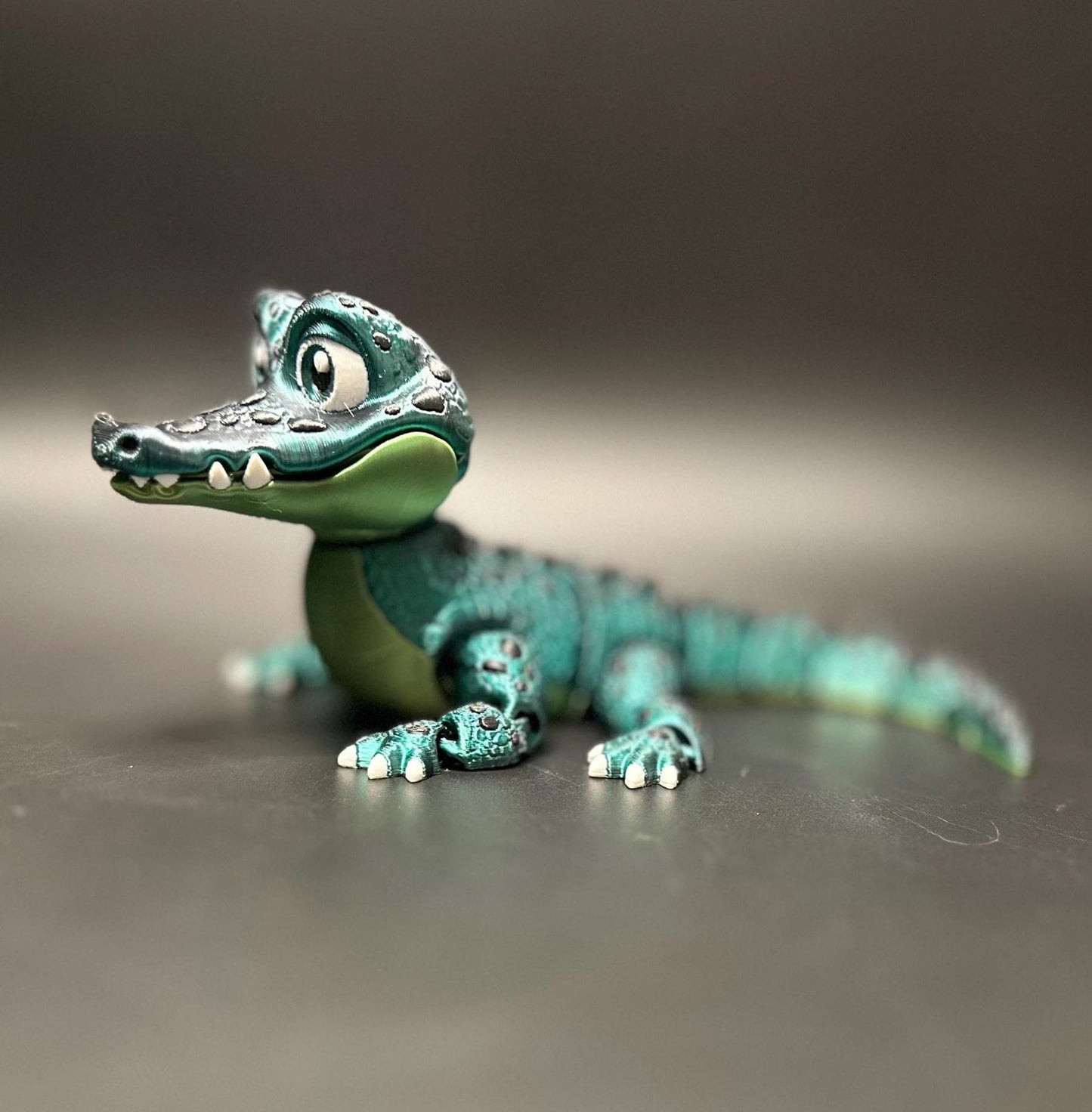A posable, 3D-printed crocodile figurine with moving legs, tail, and mouth. A fun collectible or desk toy for animal lovers.