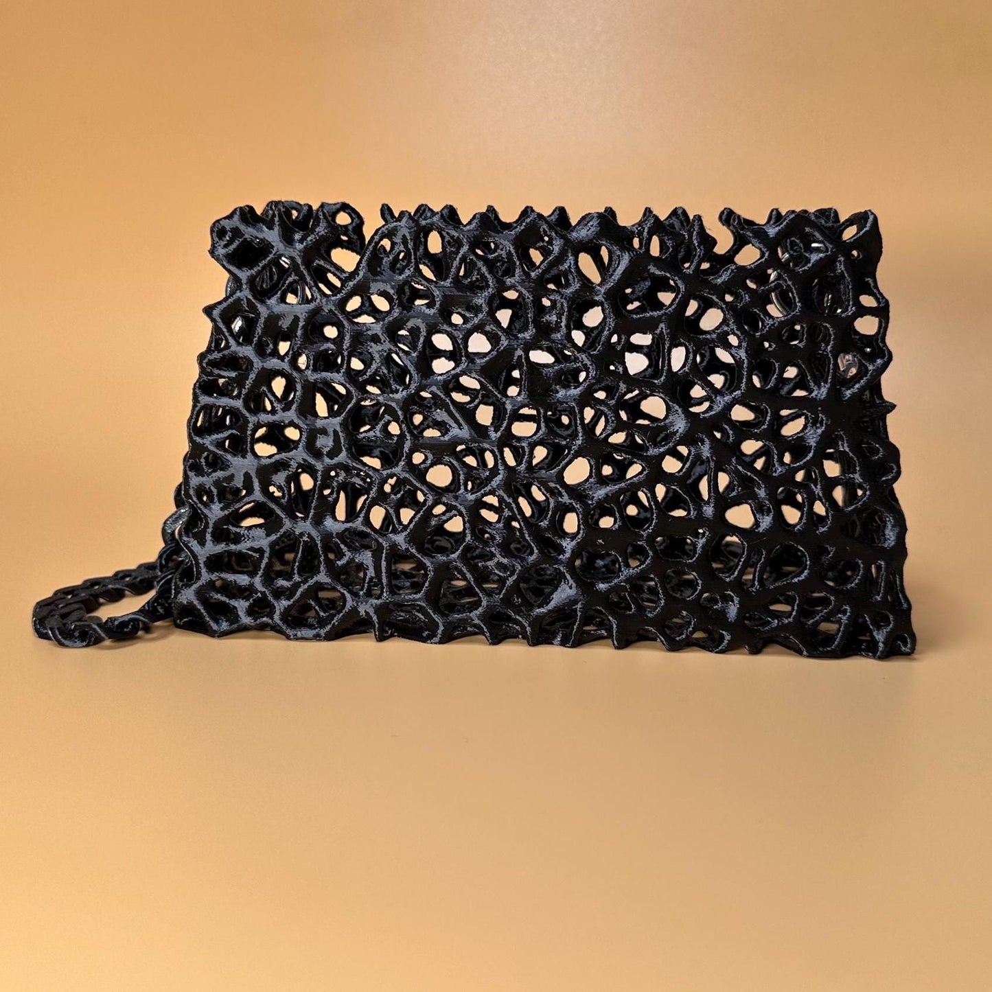 A sleek black clutch with a chain strap, suitable for gothic outfits, cosplay, or formal events.