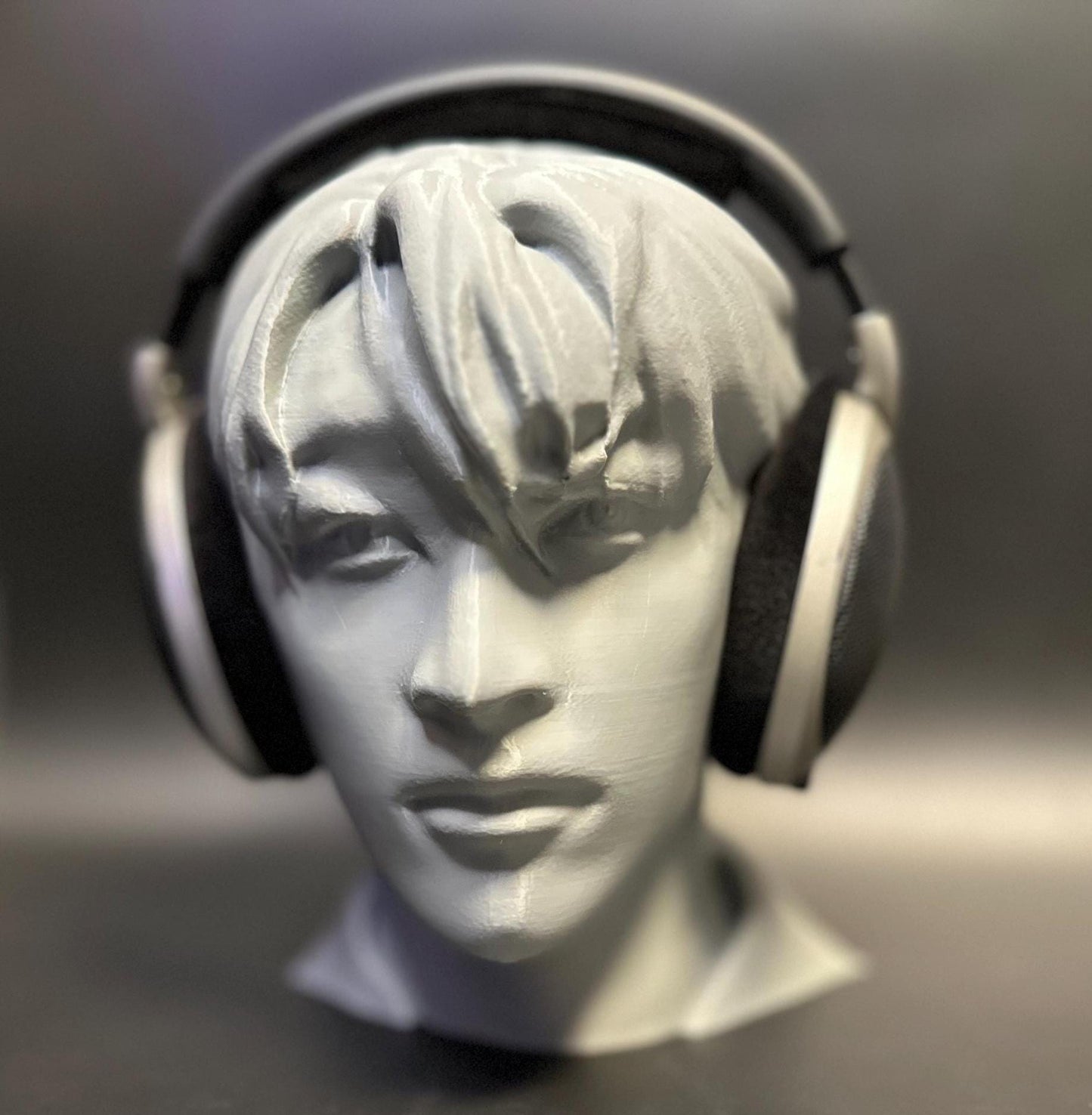 A meticulously crafted headphone stand inspired by Bang Chan. Available in various colors, including metallic finishes, showcasing sleek details and a premium design for Stray Kids fans and audiophiles alike.