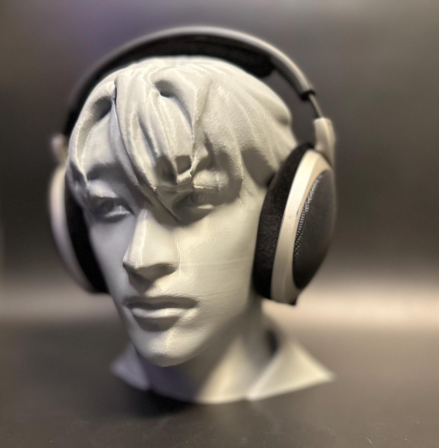 A meticulously crafted headphone stand inspired by Bang Chan. Available in various colors, including metallic finishes, showcasing sleek details and a premium design for Stray Kids fans and audiophiles alike.