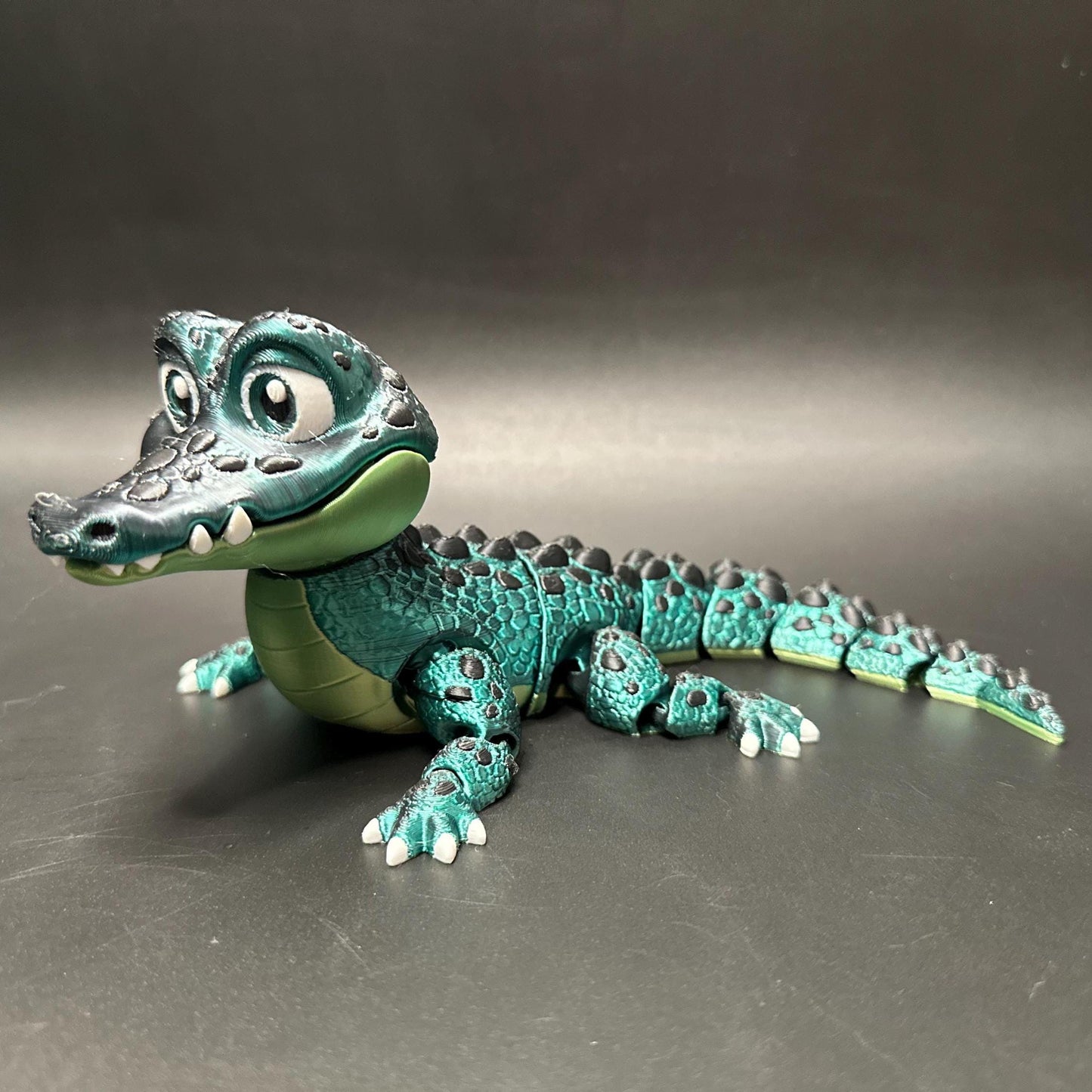 A posable, 3D-printed crocodile figurine with moving legs, tail, and mouth. A fun collectible or desk toy for animal lovers.