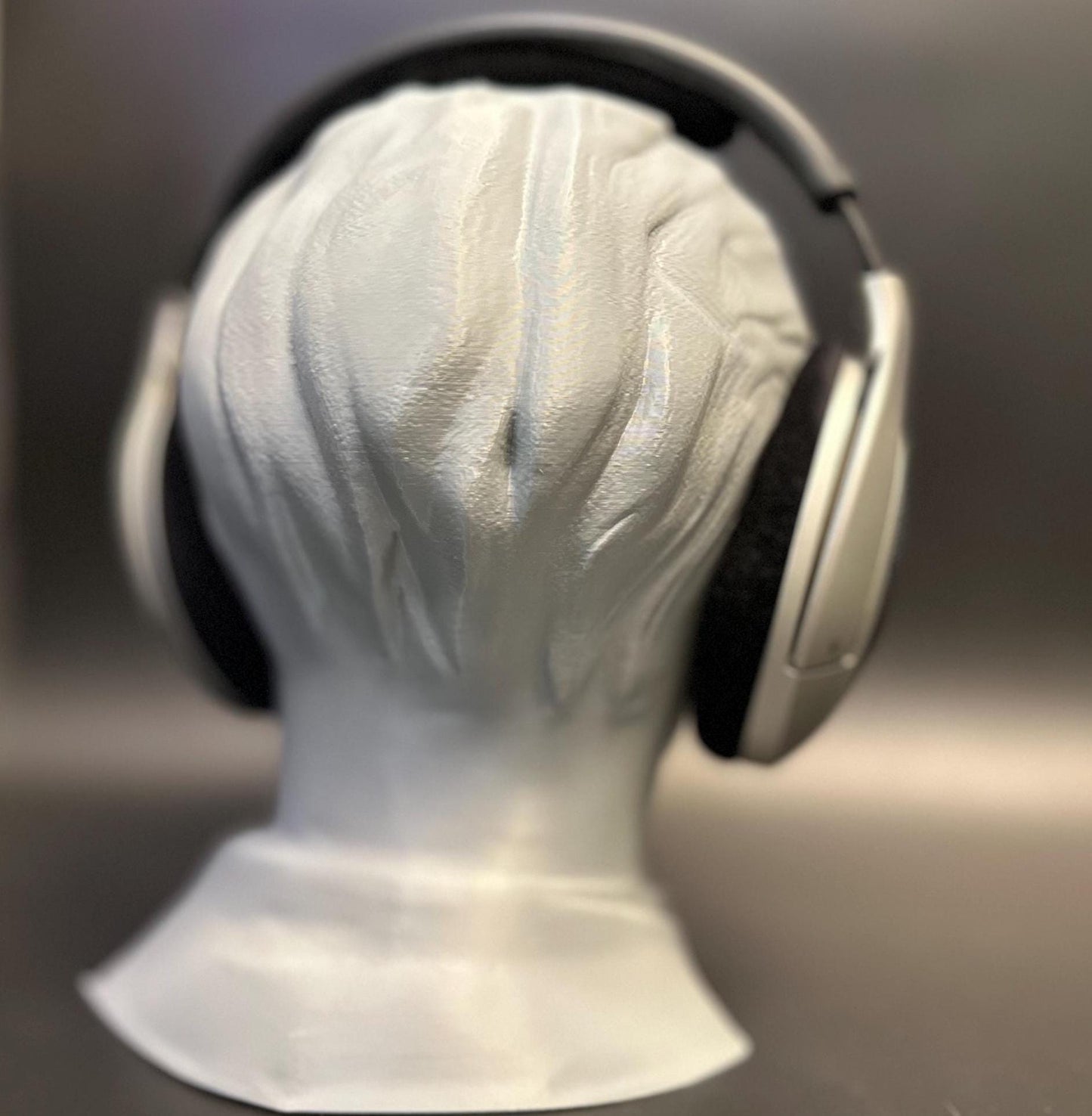 A meticulously crafted headphone stand inspired by Bang Chan. Available in various colors, including metallic finishes, showcasing sleek details and a premium design for Stray Kids fans and audiophiles alike.