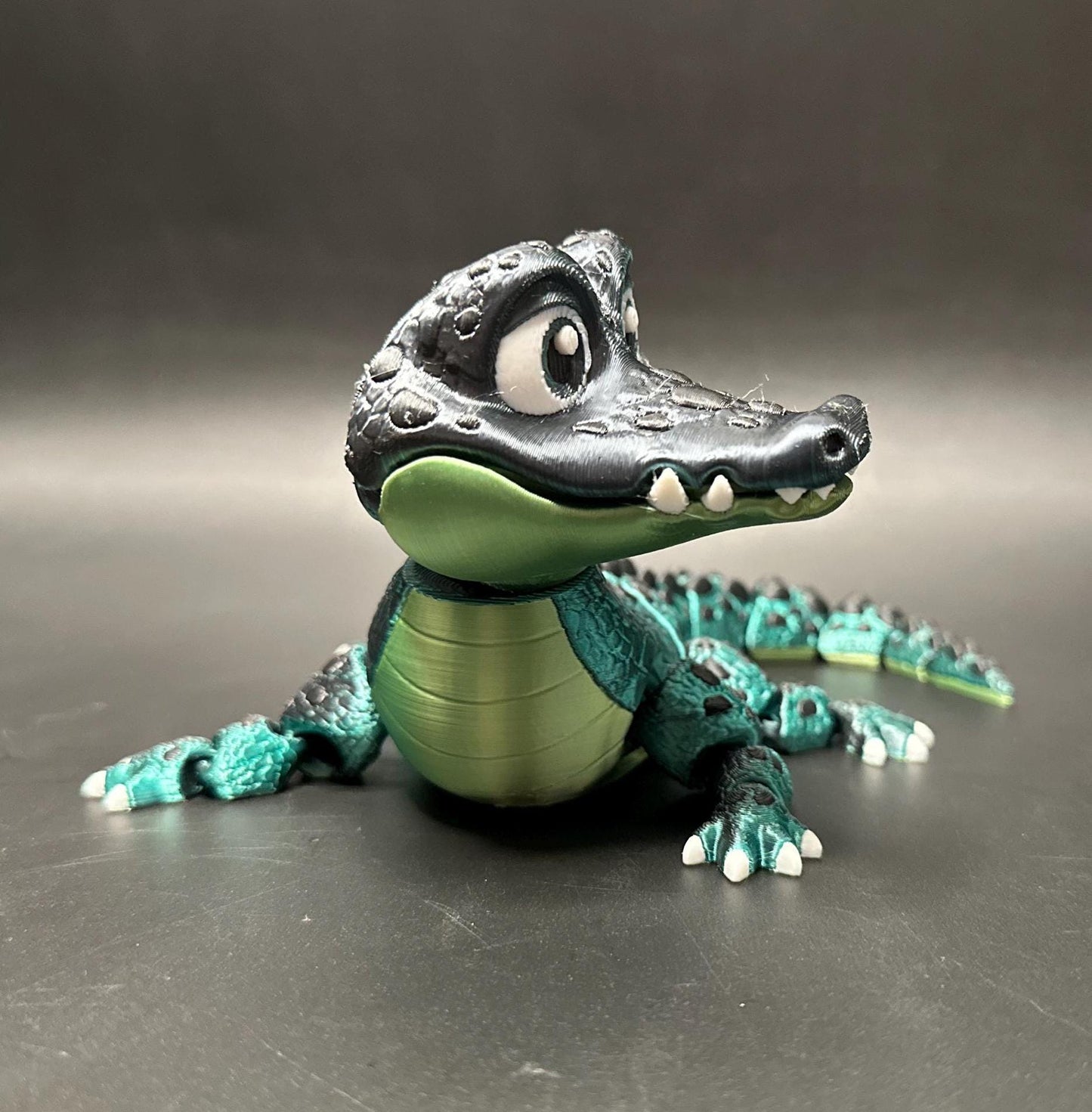 A posable, 3D-printed crocodile figurine with moving legs, tail, and mouth. A fun collectible or desk toy for animal lovers.