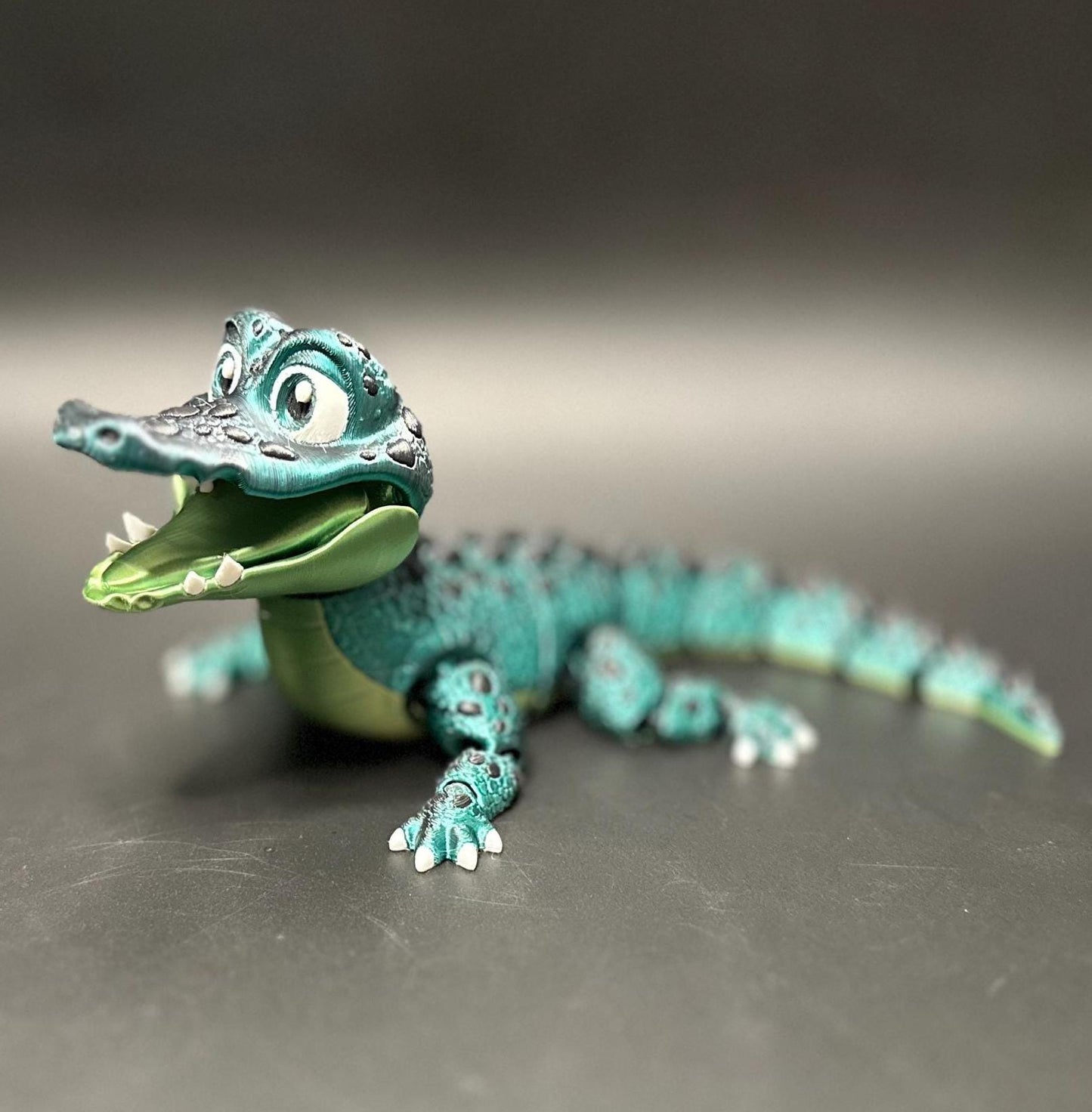 A posable, 3D-printed crocodile figurine with moving legs, tail, and mouth. A fun collectible or desk toy for animal lovers.