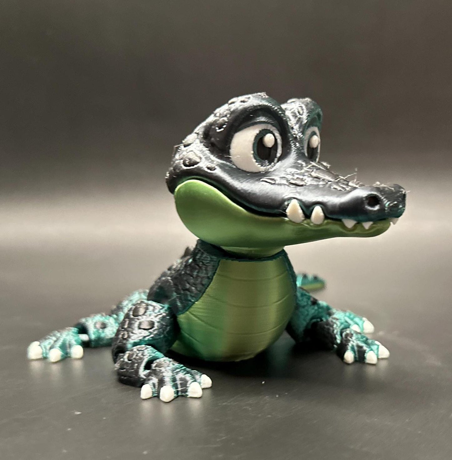 A posable, 3D-printed crocodile figurine with moving legs, tail, and mouth. A fun collectible or desk toy for animal lovers.