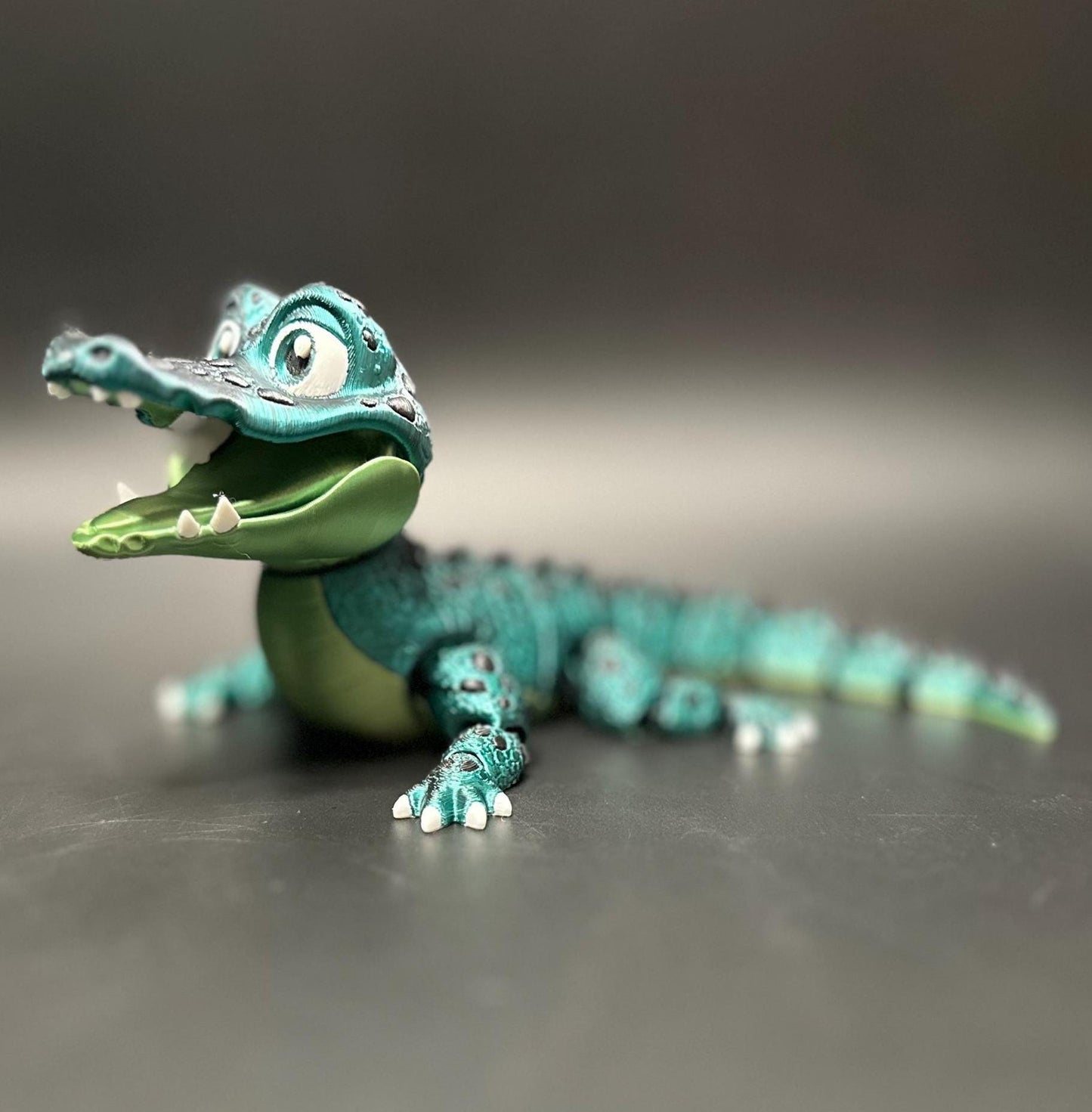 A posable, 3D-printed crocodile figurine with moving legs, tail, and mouth. A fun collectible or desk toy for animal lovers.