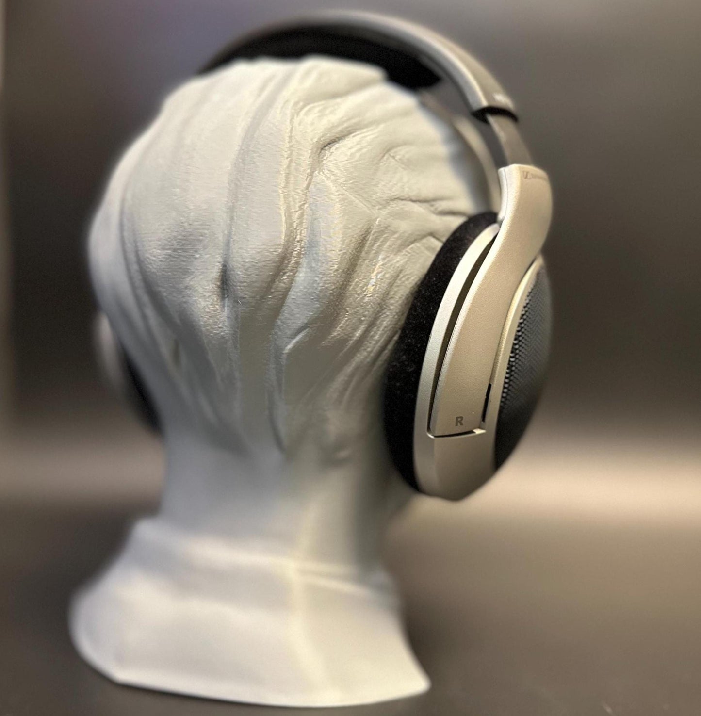 A meticulously crafted headphone stand inspired by Bang Chan. Available in various colors, including metallic finishes, showcasing sleek details and a premium design for Stray Kids fans and audiophiles alike.