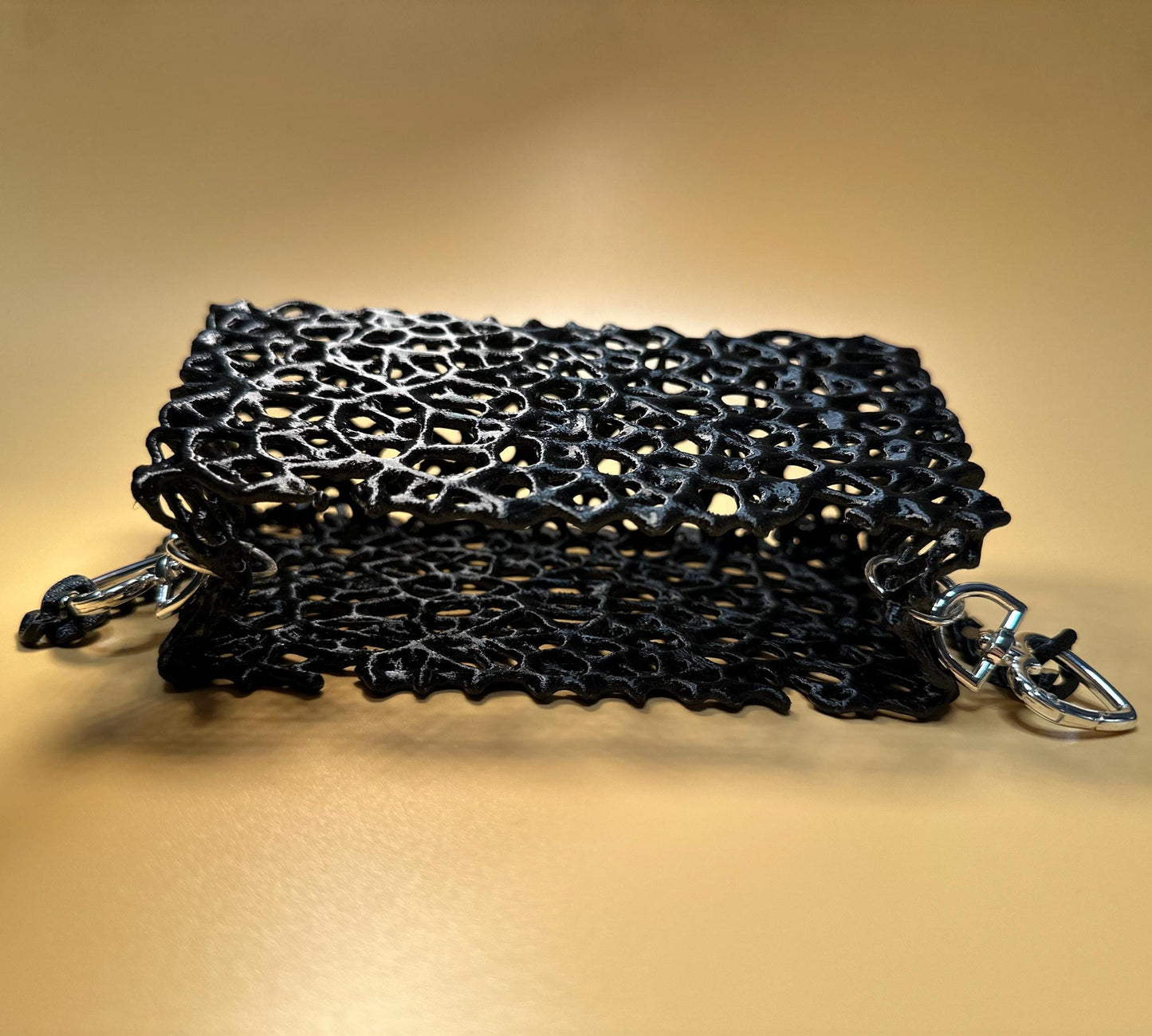 A sleek black clutch with a chain strap, suitable for gothic outfits, cosplay, or formal events.