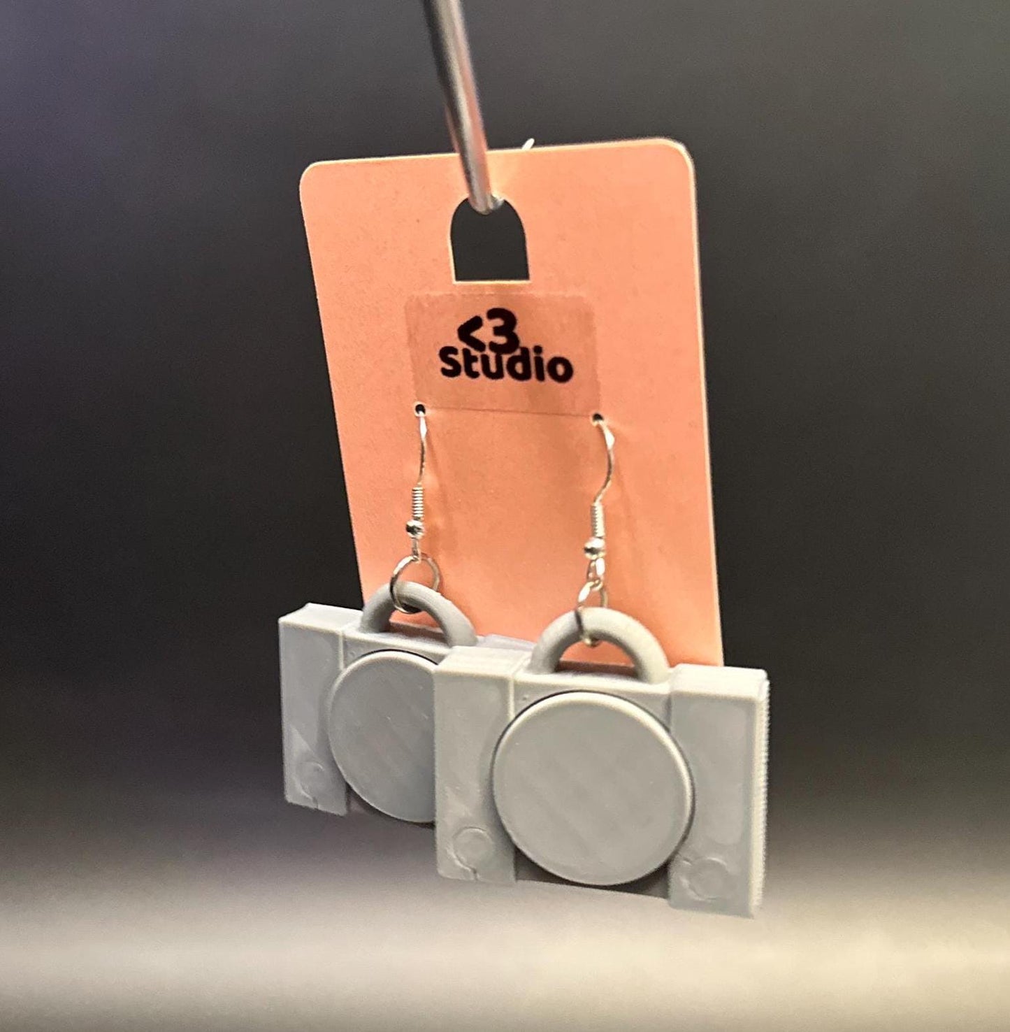 PS1 console-inspired earrings with a sleek retro design, celebrating gaming nostalgia. Lightweight and perfect for gamers and vintage enthusiasts.