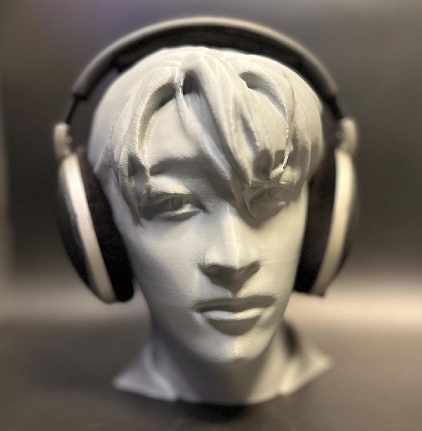 A meticulously crafted headphone stand inspired by Bang Chan. Available in various colors, including metallic finishes, showcasing sleek details and a premium design for Stray Kids fans and audiophiles alike.