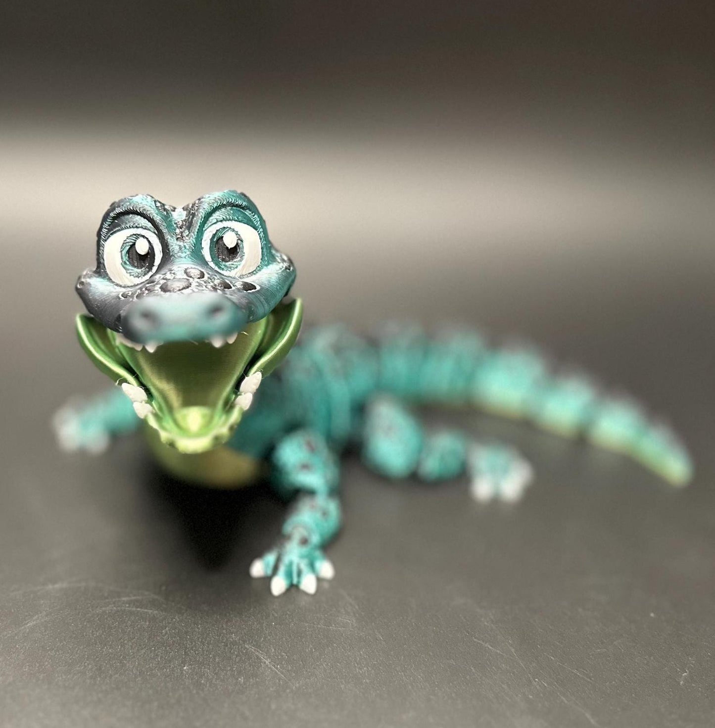 A posable, 3D-printed crocodile figurine with moving legs, tail, and mouth. A fun collectible or desk toy for animal lovers.