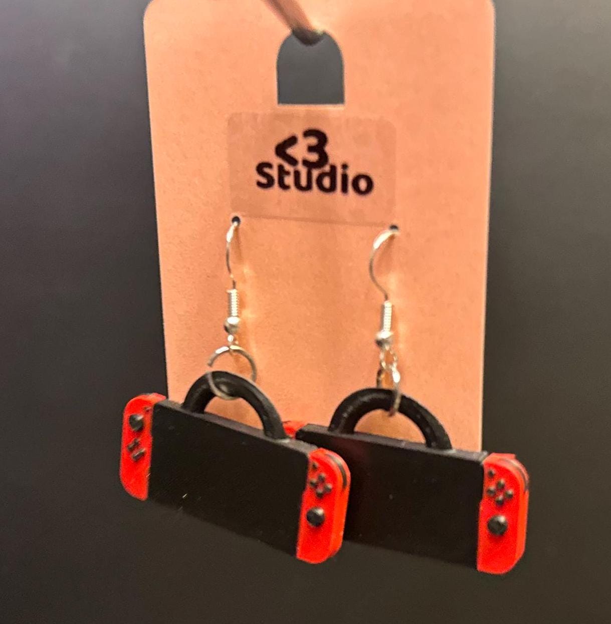 Switch-inspired console earrings with a playful and modern design, perfect for gamers seeking a fun accessory.