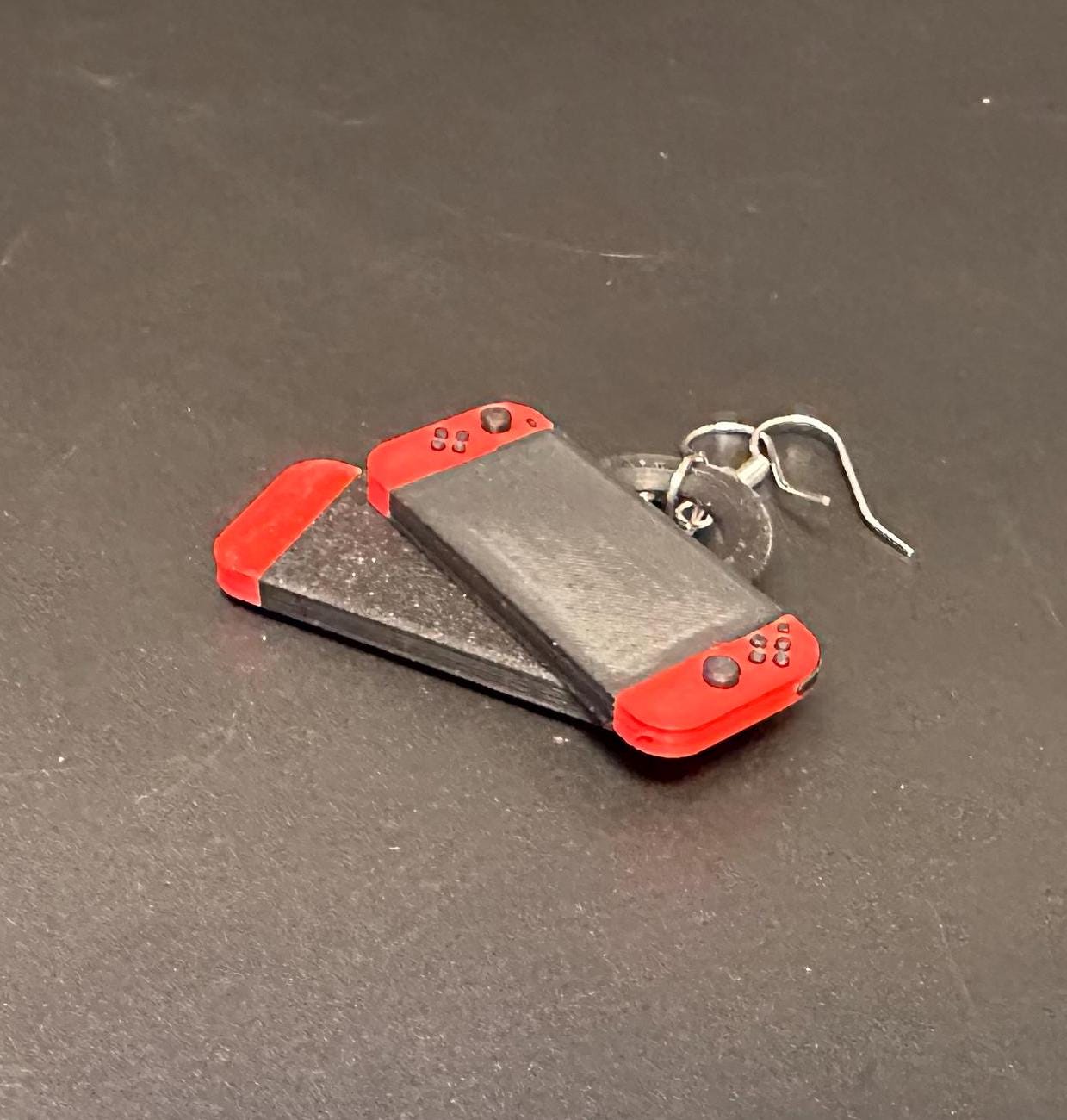 Switch-inspired console earrings with a playful and modern design, perfect for gamers seeking a fun accessory.