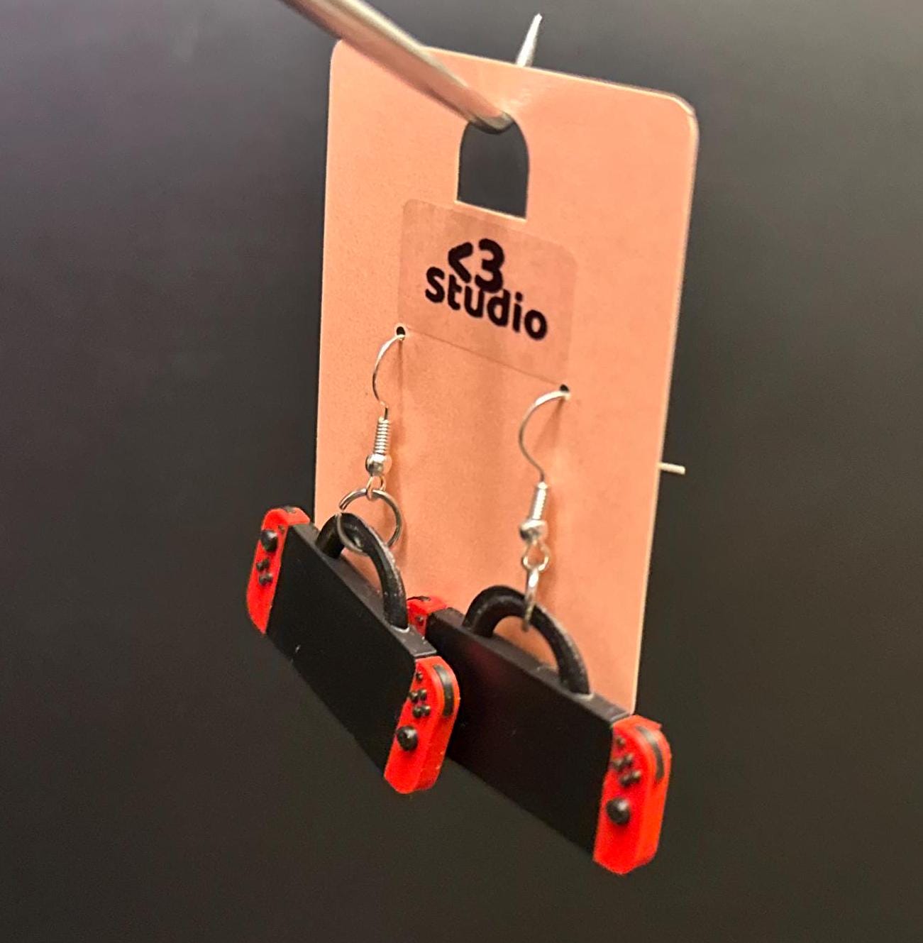 Switch-inspired console earrings with a playful and modern design, perfect for gamers seeking a fun accessory.