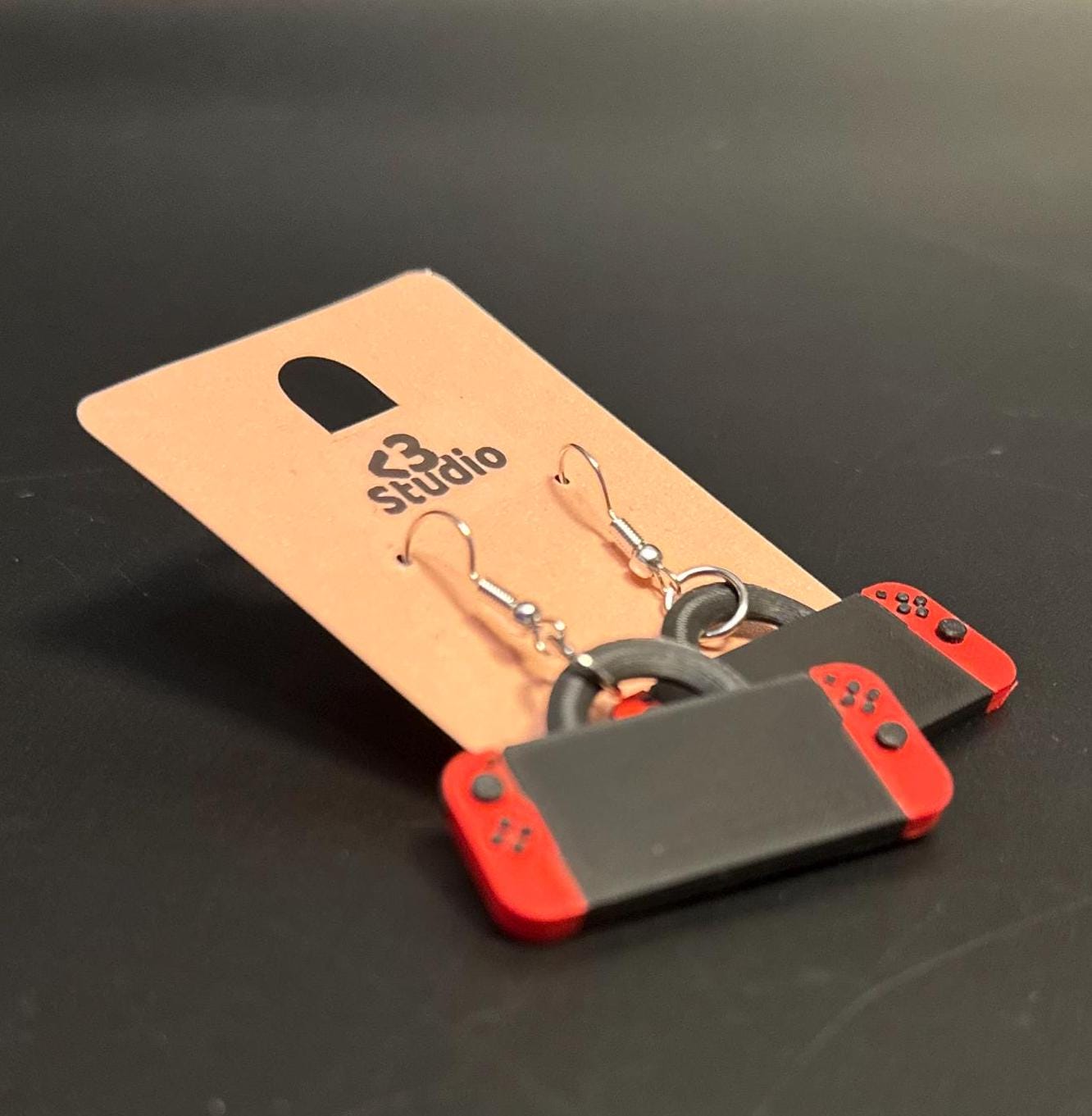 Switch-inspired console earrings with a playful and modern design, perfect for gamers seeking a fun accessory.