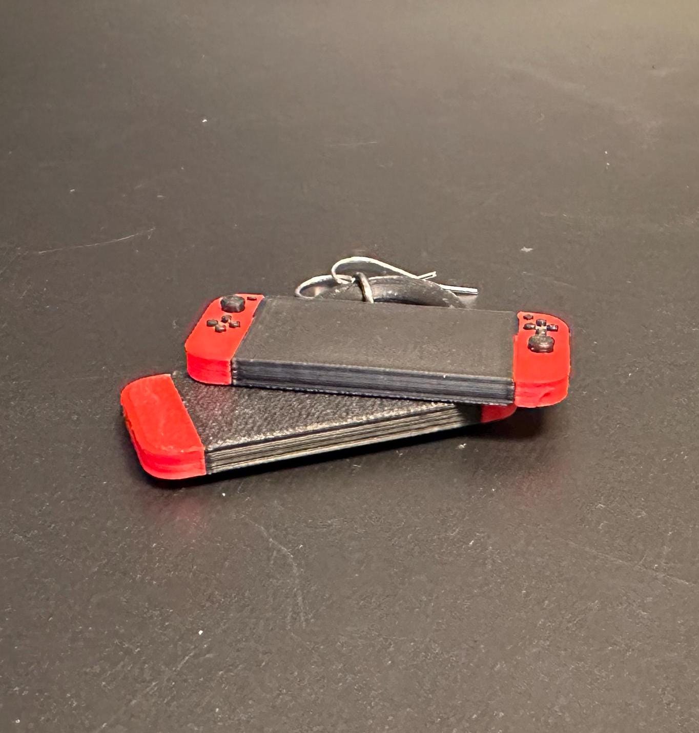 Switch-inspired console earrings with a playful and modern design, perfect for gamers seeking a fun accessory.