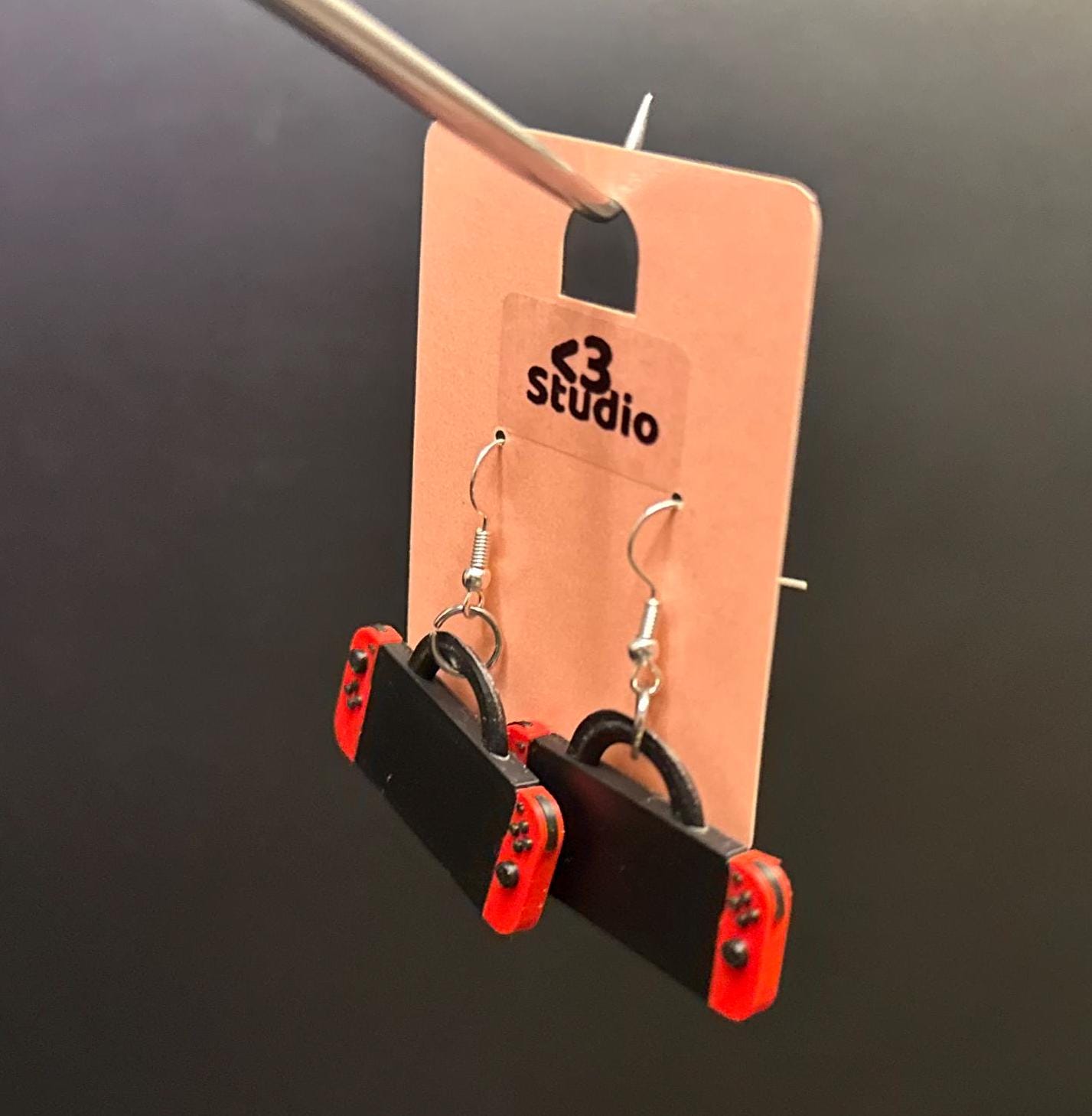 Switch-inspired console earrings with a playful and modern design, perfect for gamers seeking a fun accessory.